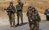 Israeli soldiers block the area near the scene of a shooting attack on a bus on road 90 in the Jordan Valley, September 4, 2022. (Nasser Ishtayeh/Flash90)