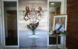 A portrait of Queen Elizabeth II and flowers at the entrance to the British embassy in Tel Aviv on September 9, 2022 (Avshalom Sassoni/Flash90)