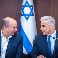 Then-Prime Minister Yair Lapid, right, with then-Alternate Prime Minister Naftali Bennett at a cabinet meeting at the Prime Minister's Office in Jerusalem on September 18, 2022. (Olivier Fitousi/Flash90)