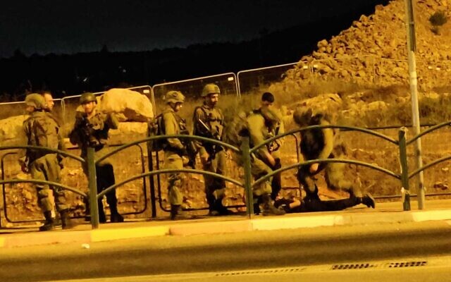 Soldiers restrain a Palestinian boy allegedly armed with a knife at the Tapuah Junction in the West Bank on September 13, 2022. (Oriah Schiff) Soldiers restrain a Palestinian boy allegedly armed with a knife at the Tapuah Junction in the West Bank on September 13, 2022. (Oriah Schiff)