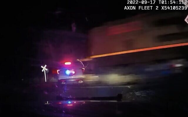 Video released by police Platteville, Colorado, shows the moment a freight train collides with a patrol car in which a suspect was being held, September 16, 2022. (Youtube screenshot, used in accordance with Clause 27a of the Copyright Law) Video released by police Platteville, Colorado, shows the moment a freight train collides with a patrol car in which a suspect was being held, September 16, 2022. (Youtube screenshot, used in accordance with Clause 27a of the Copyright Law)