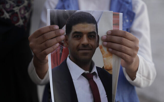 A daughter of Palestinian Mohammed Abu Kafieh holds his photo at his family house in the West Bank village of Beit Ijza, September 25, 2022 a day after he was shot and killed by Israeli forces in what Israeli army said was a ramming attack. (AP Photo/Mahmoud Illean) A daughter of Palestinian Mohammed Abu Kafieh holds his photo at his family house in the West Bank village of Beit Ijza, September 25, 2022 a day after he was shot and killed by Israeli forces in what Israeli army said was a ramming attack. (AP Photo/Mahmoud Illean)