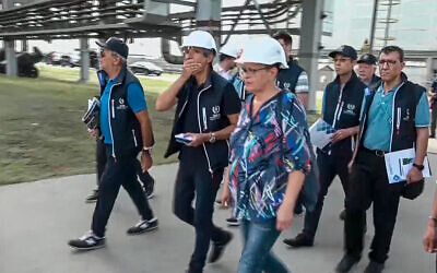 International Atomic Energy Agency (IAEA) director Rafael Grossi, the mission leader, center in white helmet, and IAEA members walk while inspecting the Zaporizhzhia Nuclear Power Plant in Enerhodar, southeastern Ukraine, September 1, 2022. (Russian Defense Ministry Press Service via AP)