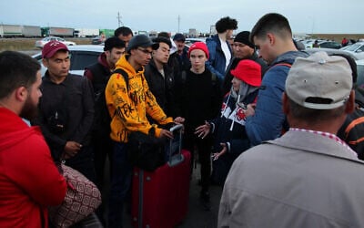 Russians arrive in Kazakhstan at the Syrym border crossing point on September 27, 2022. (AFP)