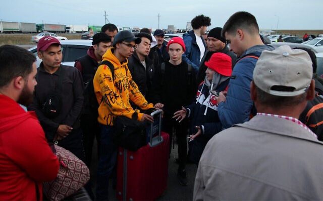 Russians arrive in Kazakhstan at the Syrym border crossing point on September 27, 2022. (AFP)