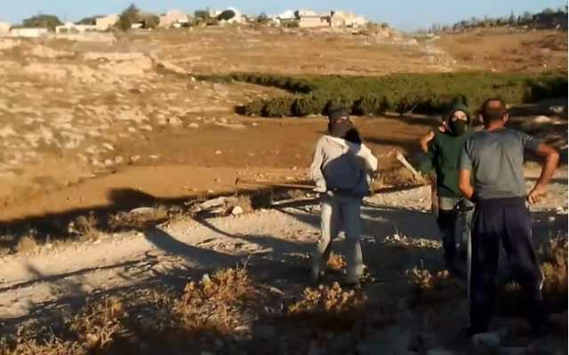 Video footage shows two masked settlers approaching a Palestinian man near the settlement of Ma’on in the South Hebron Hills area of the West Bank, before a violent confrontation ensues. (Twitter) Video footage shows two masked settlers approaching a Palestinian man near the settlement of Ma’on in the South Hebron Hills area of the West Bank, before a violent confrontation ensues. (Twitter)