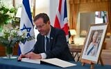 President Isaac Herzog signs a condolence book for Queen Elizabeth II at the British ambassador's residence in Tel Aviv, September 10, 2022. (Kobi Gideon/GPO)