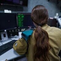 An Israeli soldier of the C4I Corps works at a computer, in an undated photo published by the military on September 21, 2022. (Israel Defense Forces)