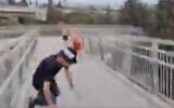 Screen capture from video of a protesters falling to the ground as two people throw rocks at a demonstration against former prime minister Benjamin Netanyahu in Rishon Lezion, September 4, 2022. (Twitter screenshot; used in accordance with Clause 27a of the Copyright Law)
