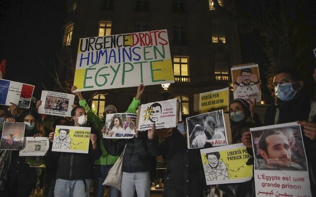 People hold placards as they stage a protest against the Egyptian President Abdel-Fattah el-Sissi close to the National Assembly in Paris, December 8, 2020. (AP Photo/Michel Euler) People hold placards as they stage a protest against the Egyptian President Abdel-Fattah el-Sissi close to the National Assembly in Paris, December 8, 2020. (AP Photo/Michel Euler)