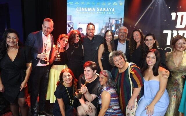 The cast and crew of 'Cinema Sabaya' pose with their Ophir Awards after winning Best Picture and other prizes, September 18, 2022. (courtesy) The cast and crew of 'Cinema Sabaya' pose with their Ophir Awards after winning Best Picture and other prizes, September 18, 2022. (courtesy)