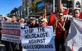 Protesters hold signs during a demonstration against the opening of the "Tsar Boris III" association, named after Boris the Third, Bulgaria's leader during World War II and a close ally of Adolf Hitler, in Ohrid, on October 7, 2022. (Robert ATANASOVSKI / AFP)