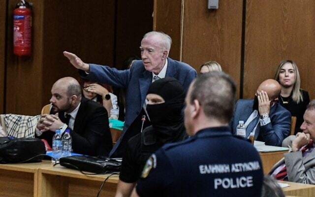 The lawyer of a jailed ex-Golden Dawn Eurodeputy (MEP), gives a Nazi salute during a hearing in the appeal trial of dozens of jailed members of Greek neo-Nazi group Golden Dawn at Athens' Court of Appeal on October 7, 2022. (Tatiana Bolari/AFP)