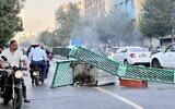 A garbage container blocks a road in the Iranian capital Tehran on October 8, 2022. (Photo obtained by AFP outside of Iran)