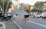 A picture obtained by AFP outside Iran, reportedly shows a garbage container on fire in the capital Tehran on October 8, 2022. (AFP)