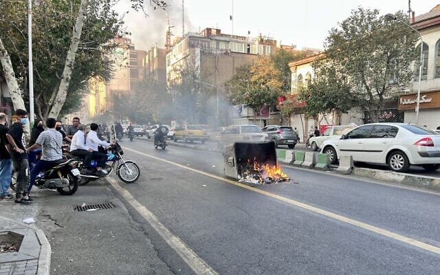 A picture obtained by AFP outside Iran, reportedly shows a garbage container on fire in the capital Tehran on October 8, 2022. (AFP) A picture obtained by AFP outside Iran, reportedly shows a garbage container on fire in the capital Tehran on October 8, 2022. (AFP)