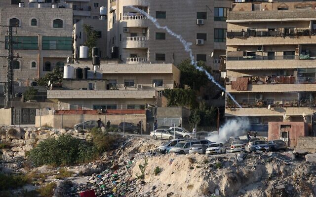 Israeli security forces use tear gas amid clashes with Palestinians, as they conduct a manhunt following a shooting attack in the Shuafat refugee camp, on October 9, 2022. (AHMAD GHARABLI/AFP) Israeli security forces use tear gas amid clashes with Palestinians, as they conduct a manhunt following a shooting attack in the Shuafat refugee camp, on October 9, 2022. (AHMAD GHARABLI/AFP)