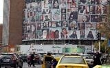 Iranians drive past a huge billboard showing a montage of pictures titled 'the women of my land, Iran' featuring Iranian women who are all observing the hijab, on Valiasr Square in Tehran, on October 13, 2022. (AFP)