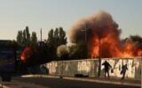 A man is seen on the ground after a blast following a drone attack in Kyiv on October 17, 2022, amid the Russian invasion of Ukraine. (Yasuyoshi CHIBA / AFP)