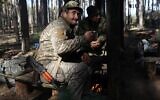 Ukrainian artillerymen stand at their position in Kharkiv region on October 17, 2022, amid the Russian military invasion of Ukraine. (Anatolii Stepanov / AFP)