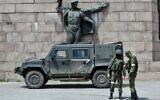 In this file photo from May 20, 2022, Russian servicemen patrol at the Eternal Flame monument in Kherson, amid the ongoing Russian invasion of Ukraine. (Olga Maltseva/AFP)