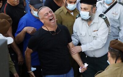 Baruch Ben-Ygal, center, reacts during the funeral of his son Amit Ben Ygal, a 21-year-old Israeli army soldier who was killed in the village of Yaabed near the West Bank city of Jenin,  at the Beer Yaakov military cemetery near Tel Aviv, May 12, 2020. (JACK GUEZ / AFP)