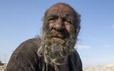 In this file photo taken on December 28, 2018, Amou Haji (uncle Haji) sits on the outskirts of the village of Dezhgah in the Dehram district of the southwestern Iranian Fars province. (AFP)