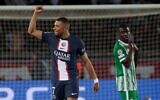 Paris Saint-Germain's French forward Kylian Mbappe celebrates after scoring his team's fifth goal  during the UEFA Champions League Group H second leg football match between Paris Saint-Germain (PSG) and Maccabi Haifa FC at the Parc des Princes stadium in Paris on October 25, 2022. (Geoffroy VAN DER HASSELT / AFP)