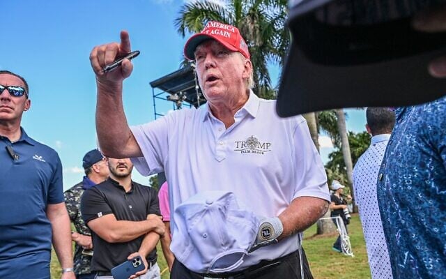 Former US President Donald Trump signs autographs as he walks off the seventh green a day ahead of the 2022 LIV Golf Invitational Miami at Trump National Doral Miami golf club in Miami, Florida, October 27, 2022. (Giorgio Viera/AFP) Former US President Donald Trump signs autographs as he walks off the seventh green a day ahead of the 2022 LIV Golf Invitational Miami at Trump National Doral Miami golf club in Miami, Florida, October 27, 2022. (Giorgio Viera/AFP)