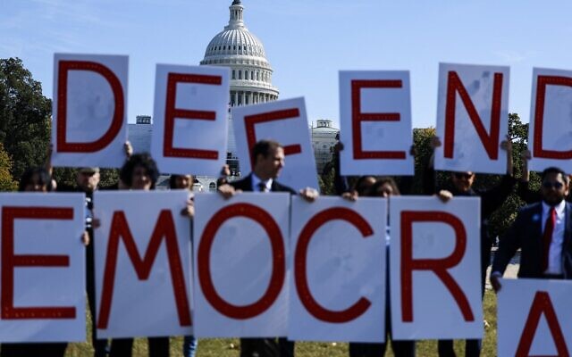Activists hold up signs spelling out 'Defend Democracy' during a protest to call on accountability for the January 6th attack on the US Capitol Building on the National Mall in Washington, DC, on October 20, 2022. (Anna Moneymaker/Getty Images/AFP) Activists hold up signs spelling out 'Defend Democracy' during a protest to call on accountability for the January 6th attack on the US Capitol Building on the National Mall in Washington, DC, on October 20, 2022. (Anna Moneymaker/Getty Images/AFP)