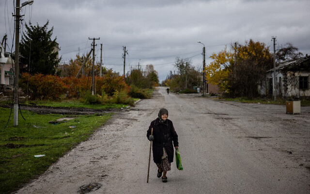 An elderly woman walks down a street to get her pension from a Ukraine post office car in the village of Drobysheve in eastern Ukraine's Donetsk region, on October 28, 2022. (Dimitar Dilkoff/AFP) An elderly woman walks down a street to get her pension from a Ukraine post office car in the village of Drobysheve in eastern Ukraine's Donetsk region, on October 28, 2022. (Dimitar Dilkoff/AFP)