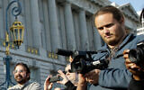 David DePape, right, records the nude wedding of Gypsy Taub outside City Hall on Dec. 19, 2013, in San Francisco. (AP Photo/Eric Risberg)