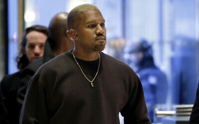 In this Dec. 13, 2016, file photo, Kanye West enters Trump Tower in New York. (AP Photo/Seth Wenig)