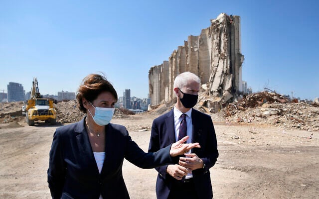 French Foreign Trade Minister Franck Riester, right and the French Ambassador to Lebanon Anne Grillo, visit Beirut's port, devastated in a massive deadly explosion in August last year, in Beirut, Lebanon, Tuesday, July 13, 2021.  (AP Photo/Hassan Ammar)