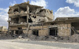 A building damaged by Syrian government forces following clashes with rebel fighters is seen in the southern city of Daraa, Syria, September 12, 2021. (AP Photo)