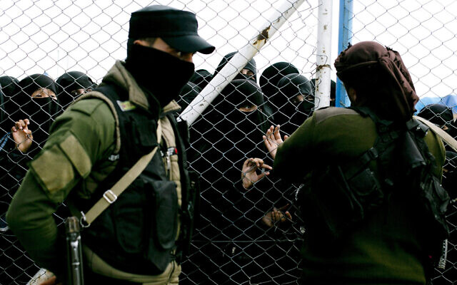 FILE - Women speak to guards at the gate that closes off the section for foreign families who lived in the Islamic State's so-called caliphate, at Al-Hol camp in Hasakeh province, Syria, March 31, 2019. (AP Photo/Maya Alleruzzo, File) FILE - Women speak to guards at the gate that closes off the section for foreign families who lived in the Islamic State's so-called caliphate, at Al-Hol camp in Hasakeh province, Syria, March 31, 2019. (AP Photo/Maya Alleruzzo, File)
