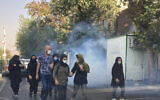 Illustrative: In this photo taken by an individual not employed by the Associated Press and obtained by the AP outside Iran, tear gas is fired by security to disperse protestors in front of the Tehran University in Iran, October 1, 2022. (AP Photo)