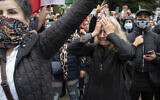 A woman identified as Nasi cries during a rally calling for regime change in Iran following the death of Mahsa Amini, a young woman who died after being arrested in Tehran by Iran's notorious 'morality police,' in Washington, Saturday, Oct. 1, 2022. Nasi's daughter was killed Jan. 8, 2020, when the Islamic Revolutionary Guard Corps shot down a Ukraine International Airlines Flight 752 passenger airliner killing all 176 aboard. (AP/Cliff Owen)