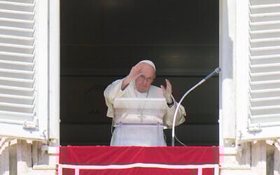 Pope Francis waves during the Angelus noon prayer from the window of his studio overlooking St. Peter's Square, at the Vatican, October 2, 2022. (AP Photo/Alessandra Tarantino)