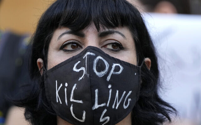 An activist wears a message on her protective face mask "Stop Killing Us" during a protest against the death of Iranian Mahsa Amini in Iran, in Beirut, Lebanon, Sunday, Oct. 2, 2022.(AP/Hassan Ammar) An activist wears a message on her protective face mask "Stop Killing Us" during a protest against the death of Iranian Mahsa Amini in Iran, in Beirut, Lebanon, Sunday, Oct. 2, 2022.(AP/Hassan Ammar)