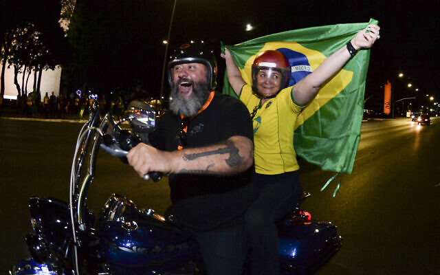 Supporters of Brazilian President Jair Bolsonaro ride a motorcycle after the general election polls closed in Brasilia, Brazil, Sunday, Oct. 2, 2022. (AP/Ton Molina) Supporters of Brazilian President Jair Bolsonaro ride a motorcycle after the general election polls closed in Brasilia, Brazil, Sunday, Oct. 2, 2022. (AP/Ton Molina)
