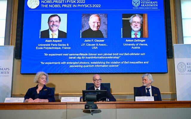 Royal Swedish Academy of Sciences secretary general Hans Ellegren, center announces the winner of the 2022 Nobel Prize in Physics, from left to right on the screen, Alain Aspect, John F. Clauser and Anton Zeilinger, in Stockholm, Sweden, Oct. 4, 2022. (Jonas Ekstromer /TT News Agency via AP) Royal Swedish Academy of Sciences secretary general Hans Ellegren, center announces the winner of the 2022 Nobel Prize in Physics, from left to right on the screen, Alain Aspect, John F. Clauser and Anton Zeilinger, in Stockholm, Sweden, Oct. 4, 2022. (Jonas Ekstromer /TT News Agency via AP)