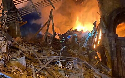 Rescuers work at the scene of a building damaged by shelling in Zaporizhzhia, Ukraine, October 6, 2022. (Ukrainian Emergency Service via AP )