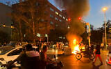 In this photo taken by an individual not employed by the Associated Press and obtained by the AP outside Iran, a police motorcycle and a trash bin are burning during a protest over the death of Mahsa Amini, a 22-year-old woman who had been detained by the nation's morality police on September 19, 2022,  in downtown Tehran, Iran. (AP)