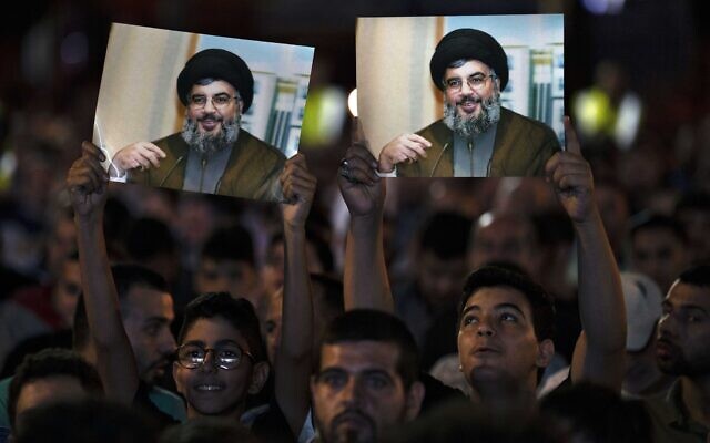 Hezbollah supporters hold up portraits of Hezbollah leader Sayyed Hassan Nasrallah as he speaks via a video link during a ceremony marking Prophet Muhammad's birthday, in the southern Beirut suburb of Dahiyeh, Lebanon, Tuesday, Oct. 11, 2022. (AP Photo/Bilal Hussein) Hezbollah supporters hold up portraits of Hezbollah leader Sayyed Hassan Nasrallah as he speaks via a video link during a ceremony marking Prophet Muhammad's birthday, in the southern Beirut suburb of Dahiyeh, Lebanon, Tuesday, Oct. 11, 2022. (AP Photo/Bilal Hussein)