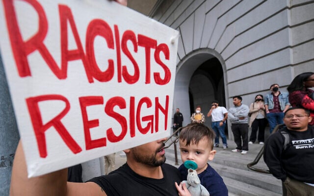 Shervin Aazami holding his son Barrett and a sign protest outside City Hall during the Los Angeles City Council meeting, October 11, 2022 in Los Angeles. (AP/Ringo H.W. Chiu) Shervin Aazami holding his son Barrett and a sign protest outside City Hall during the Los Angeles City Council meeting, October 11, 2022 in Los Angeles. (AP/Ringo H.W. Chiu)