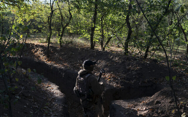 A Ukrainian serviceman checks the trenches dug by Russian soldiers in a retaken area in Kherson region, Ukraine, October 12, 2022. (AP Photo/Leo Correa) A Ukrainian serviceman checks the trenches dug by Russian soldiers in a retaken area in Kherson region, Ukraine, October 12, 2022. (AP Photo/Leo Correa)