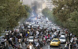 Protesters chant slogans during a protest over the death of a woman who was detained by the morality police, in downtown Tehran, Iran, September 21, 2022. (AP Photo, File)