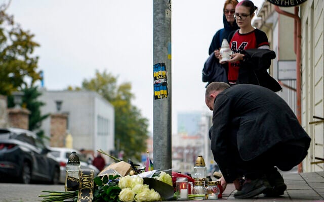 People lay flowers and light candles at the scene of Wednesday's attack on Zamocka Street in Bratislava, Slovakia, October 13, 2022. (Pavol Zachar/TASR via AP) People lay flowers and light candles at the scene of Wednesday's attack on Zamocka Street in Bratislava, Slovakia, October 13, 2022. (Pavol Zachar/TASR via AP)