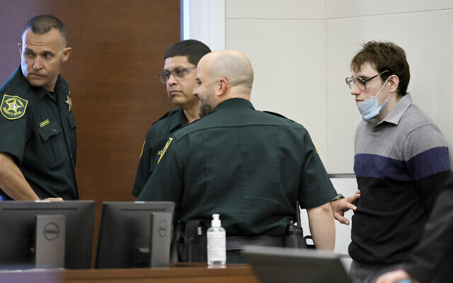 Marjory Stoneman Douglas High School shooter Nikolas Cruz leans against a wall waiting to be escorted from the courtroom as the jury resumes deliberations in the penalty phase of his trial at the Broward County Courthouse in Fort Lauderdale, Florida, on October 13, 2022. (Mike Stocker/South Florida Sun Sentinel via AP, Pool)